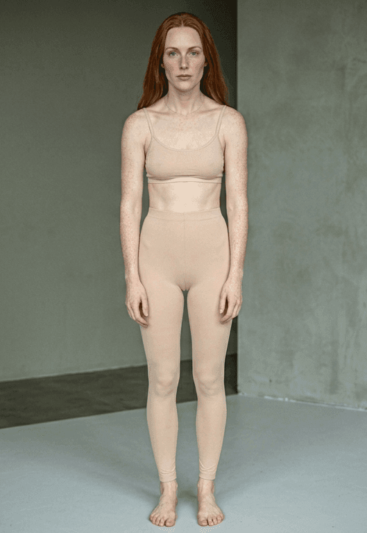 Standing photo — mild shoulder rounding visible, unguided colours that fight a cool undertone